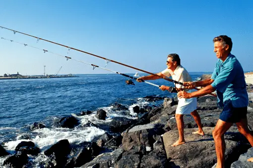 two fisherman casting surf rods
