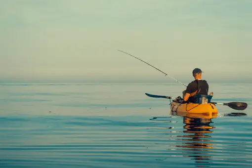 man fishing from kayak in ocean