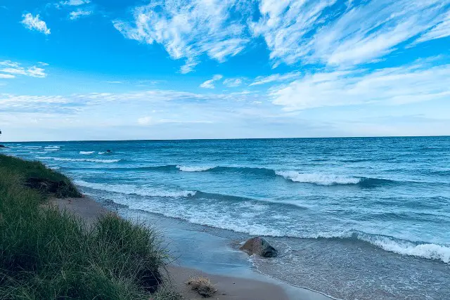small waves breaking on shore of lake michigan
