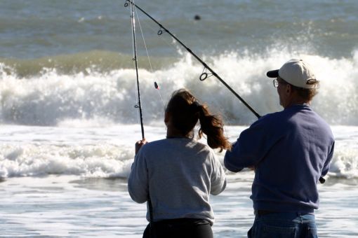couple fishing in the surf