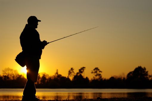 man fishing at dusk