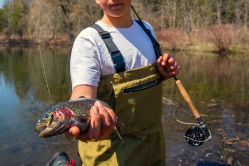angler holding a freshly caught rainbow trout