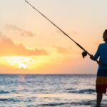 father and son surf fishing in the evening