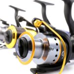 three spinning reels on a white background