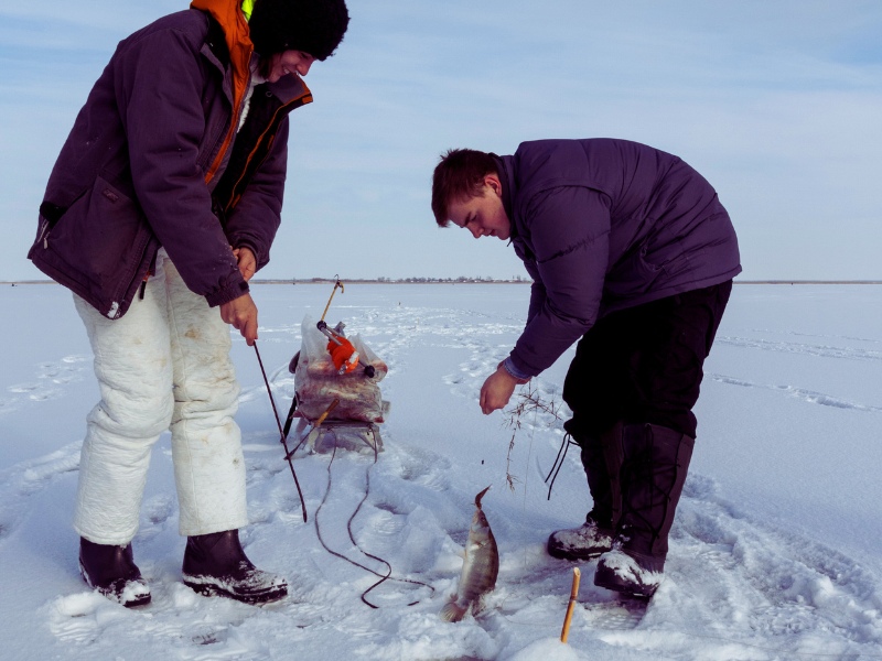 two young fishermen ice fishing