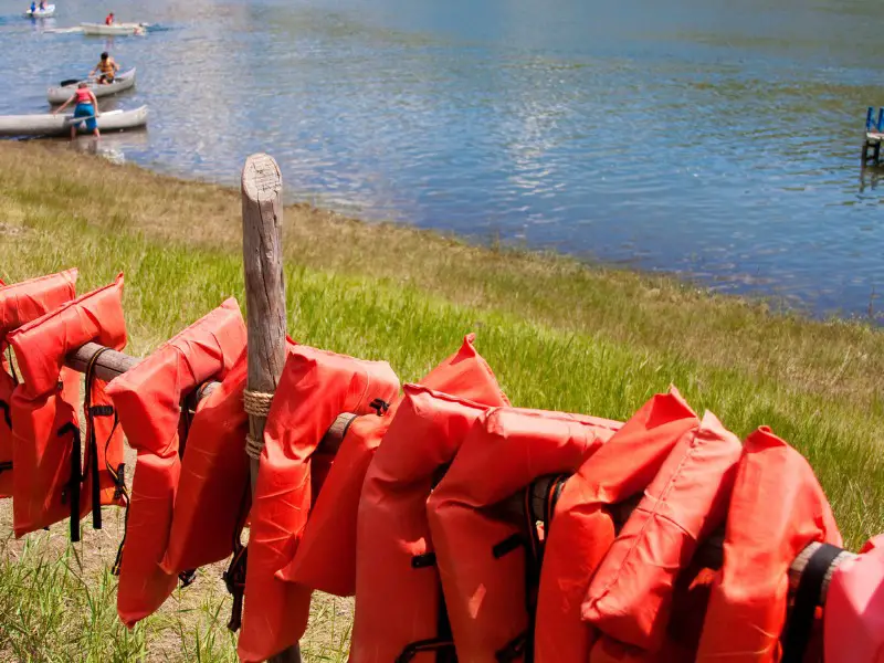 life jackets on wooden fence