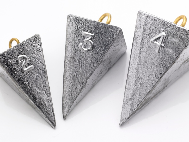 three pyramid sinkers on a white background