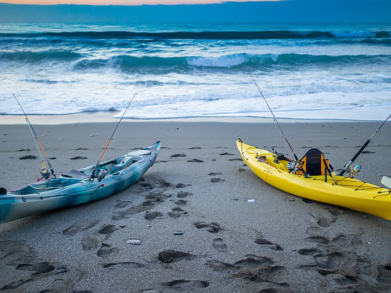 two fishing kayaks moored on a beach 